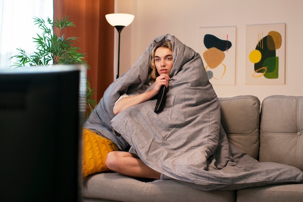 Woman watching news on tv full shot