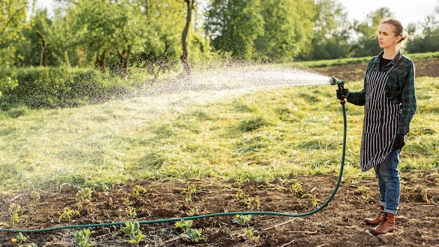 Woman watering the crops