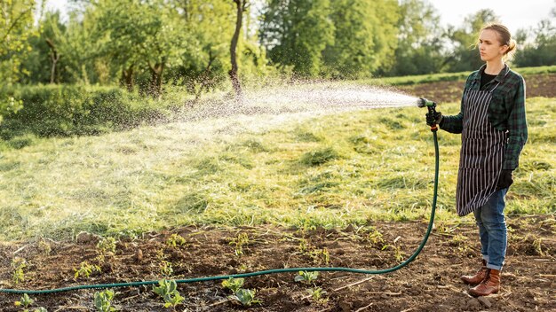 Woman watering the crops