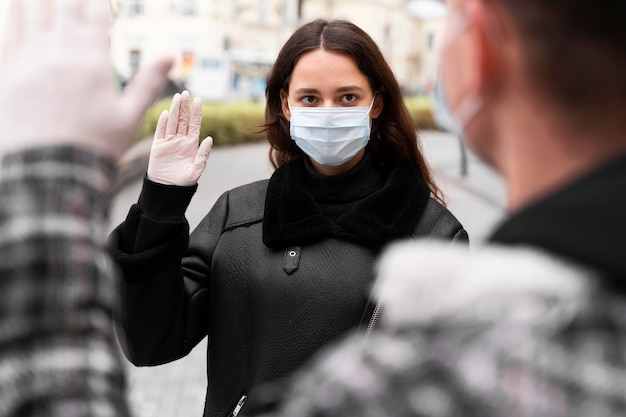 Woman waves alternative greetings