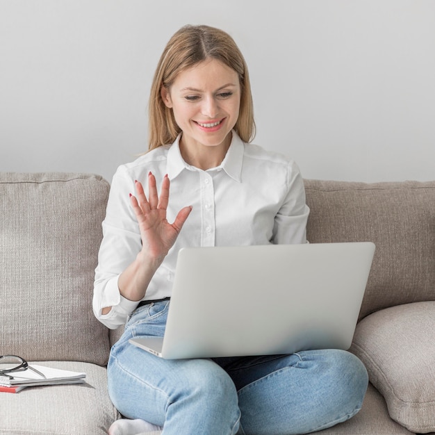 Woman waving to her class online