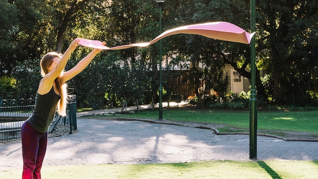 Woman waving mat before laying it