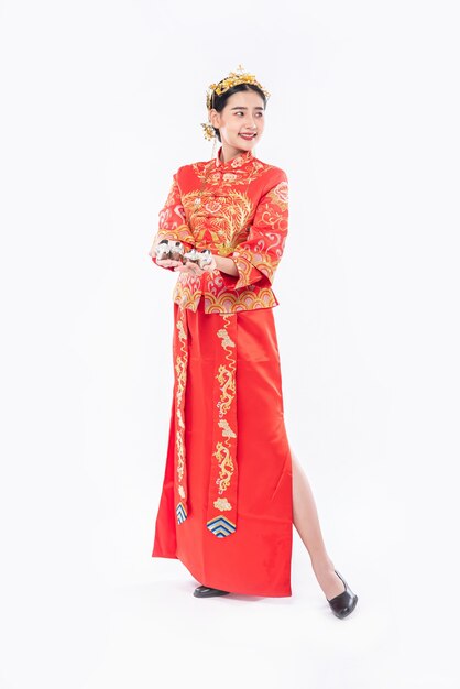 Woman wear Cheongsam suit and black shoe ready to give the gift money to relative