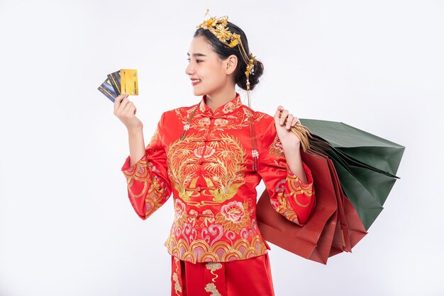 Woman wear Cheongsam suit use credit card to shopping many shop in chinese new year
