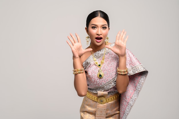 woman wear Thai clothes and open her hands on both sides.