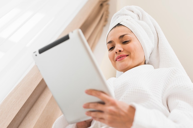 Woman wearing bathrobe in hotel room