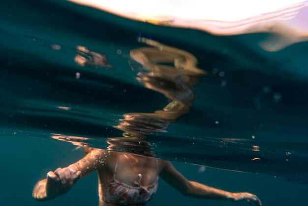 Женщина в бикини купается в океане