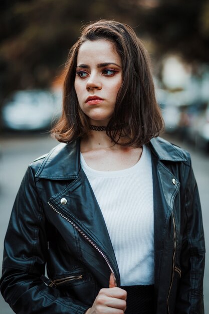 Woman Wearing Black Leather Jacket posing in the street