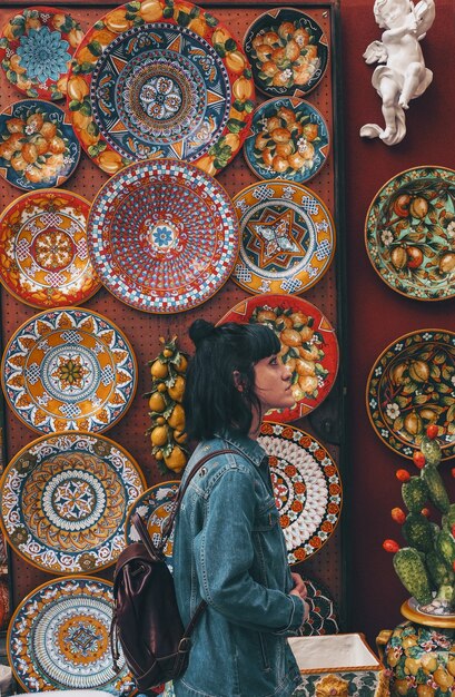 Woman wearing blue denim jacket across plates