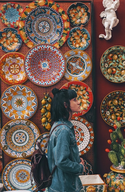 Woman wearing blue denim jacket across plates