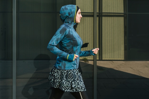 Free photo woman wearing blue jacket and training