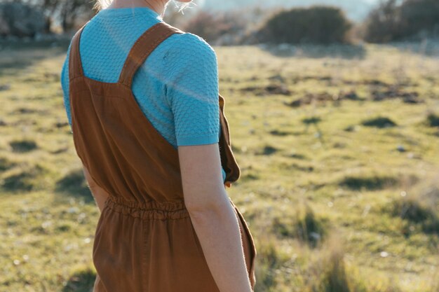 Woman wearing brown overall with t-shirt