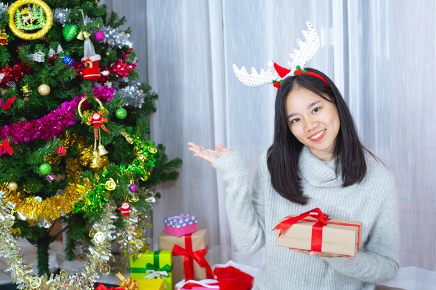 woman wearing christmas hat happy with christmas present