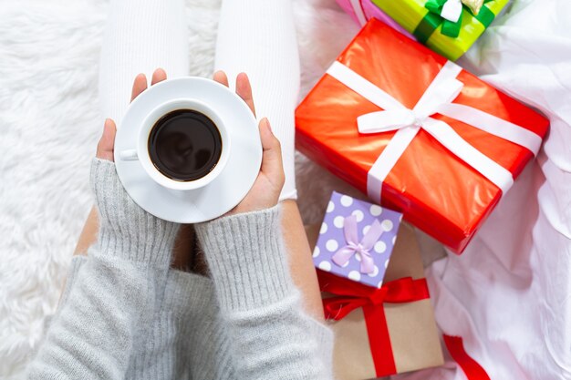 woman wearing christmas hat happy with christmas present