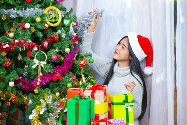 woman wearing christmas hat happy with christmas present