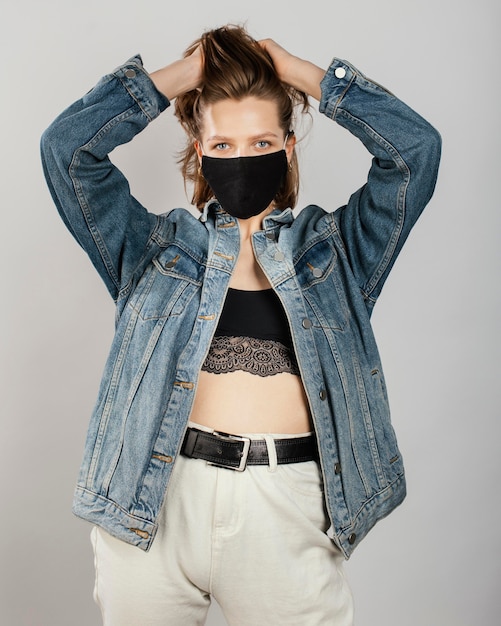 Free photo woman wearing denim jacket and mask