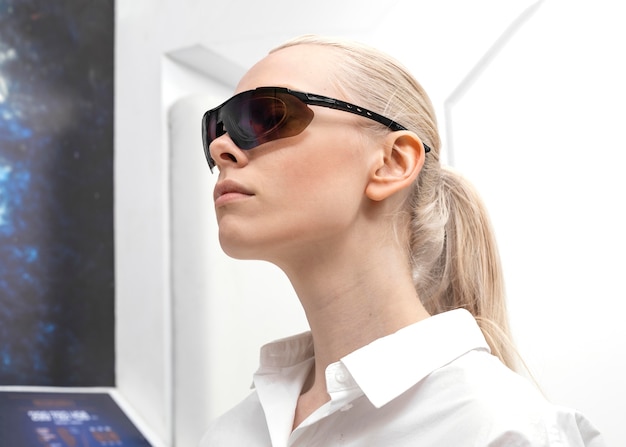 Free photo woman wearing digital glasses