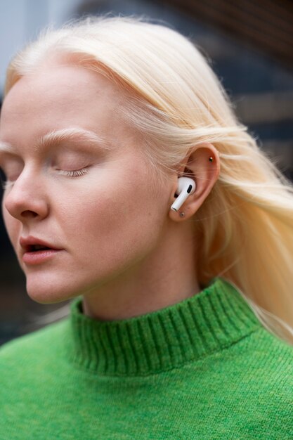 Woman wearing earphones side view