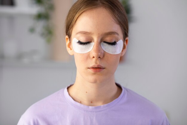 Woman wearing eye patches front view