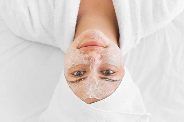 Woman wearing face cream top view