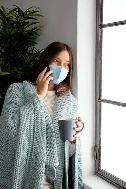 Woman wearing face mask at home