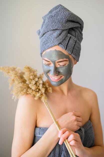 Maschera da portare da portare della donna e posare con il fiore