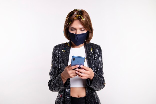 Woman wearing face mask taking a selfie