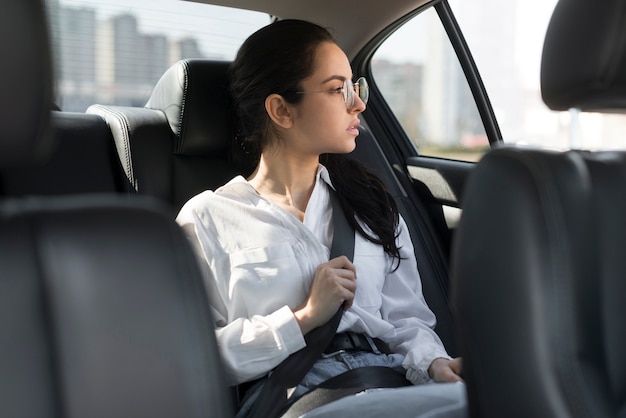 Woman wearing glasses and being a passenger