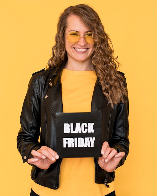 Woman wearing glasses and holding black friday label