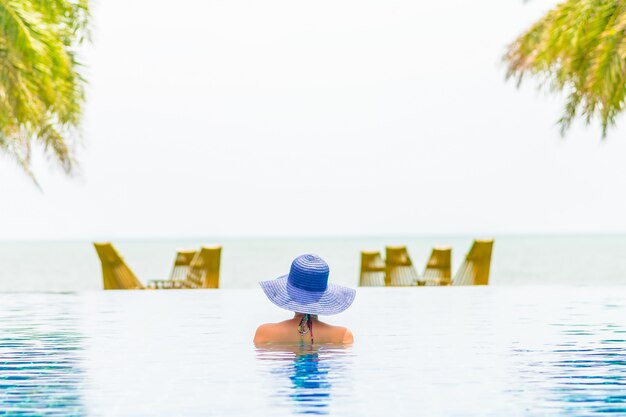 Woman wearing hat in the hotel pool resort