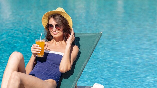 Woman wearing hat laying on lounge