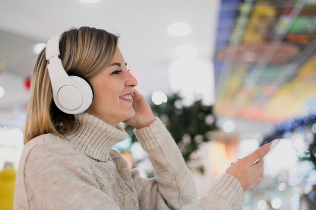 Woman wearing headphones in shopping mall