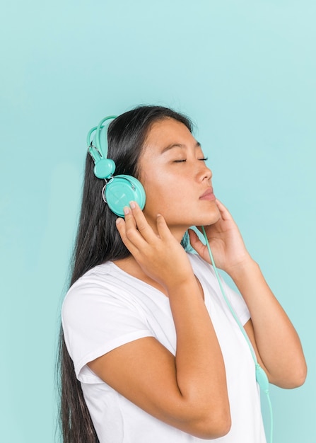 Woman wearing headphones with her eyes closed