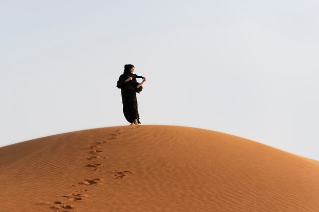 Woman wearing hijab in the desert