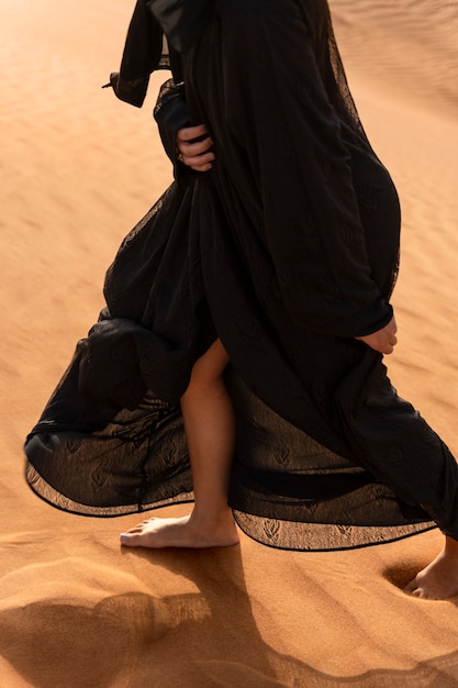 Free photo woman wearing hijab in the desert