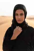 Free photo woman wearing hijab in the desert