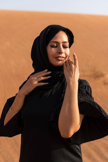 Woman wearing hijab in the desert