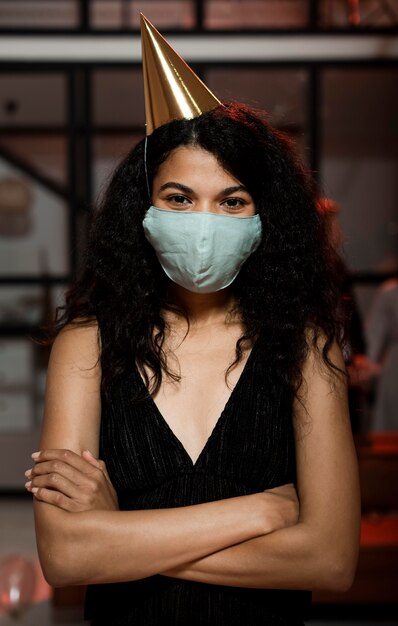 Woman wearing a medical mask on new year's eve party