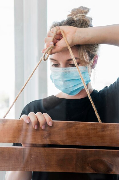 Woman wearing medical mask and working with a placard