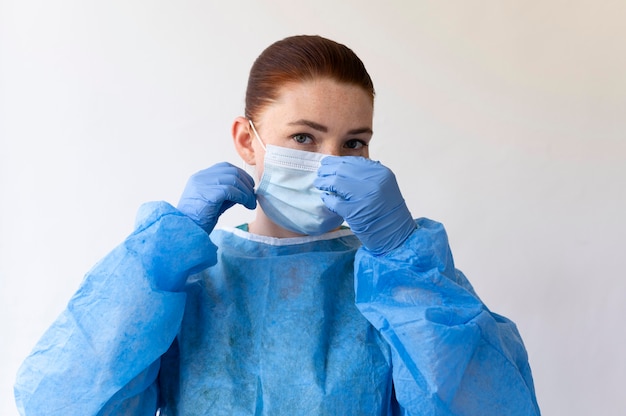 Woman wearing a medical protective equipment with surgical mask