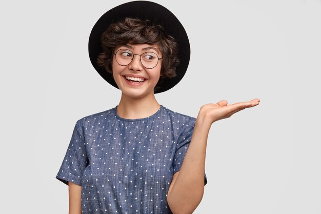 Woman wearing polka dot blouse and big hat