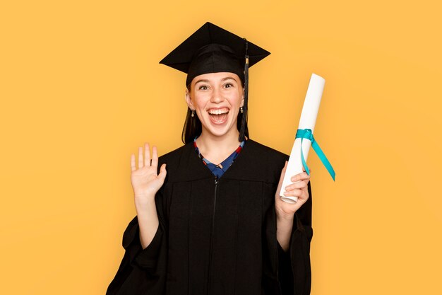 Woman wearing regalia holding her degree for graduation