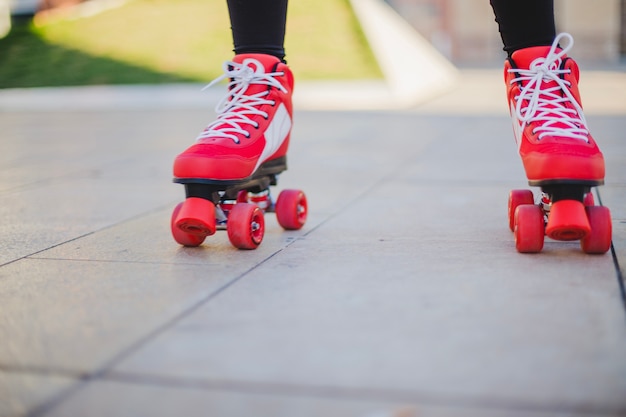 Woman wearing rollerskates riding on pavement