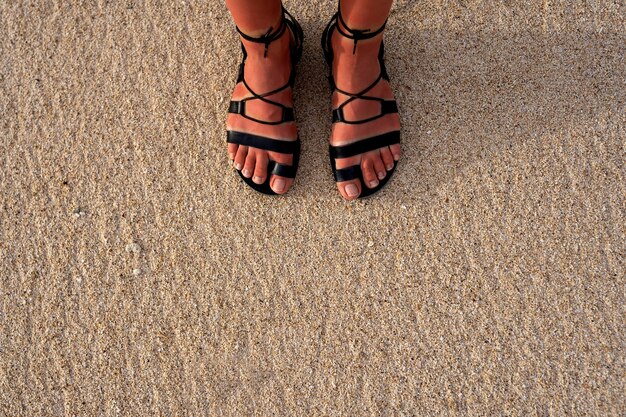 Woman wearing roman sandals at the beach