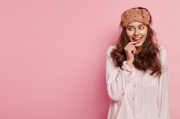 Woman wearing sleep mask and pajamas