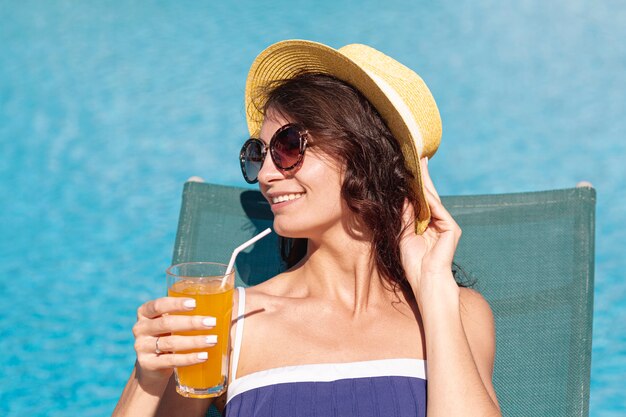 Woman wearing sunglasses laying on lounge