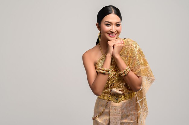 woman wearing Thai clothes and hands touching the chin