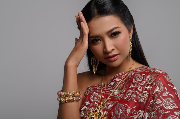 Woman wearing Thai dress that made a hand symbol