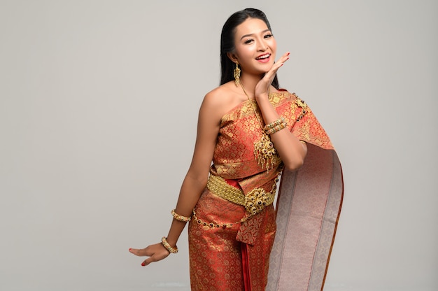 Free photo woman wearing thai dress that made a hand symbol