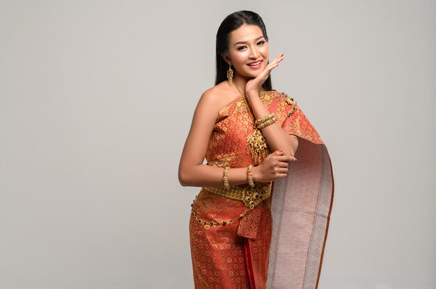 Woman wearing Thai dress that made a hand symbol